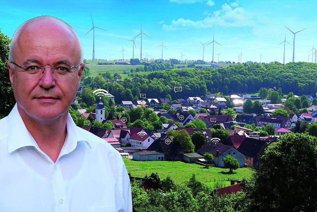 Ortsvorsteher von Etteln, Ulrich Ahle, im Interview mit dem BdSt NRW. Porträt eines Mannes vor ländlicher Kulisse mit Windrädern und digitalen Symbolen über Häusern, die Digitalisierung im Dorf symbolisieren