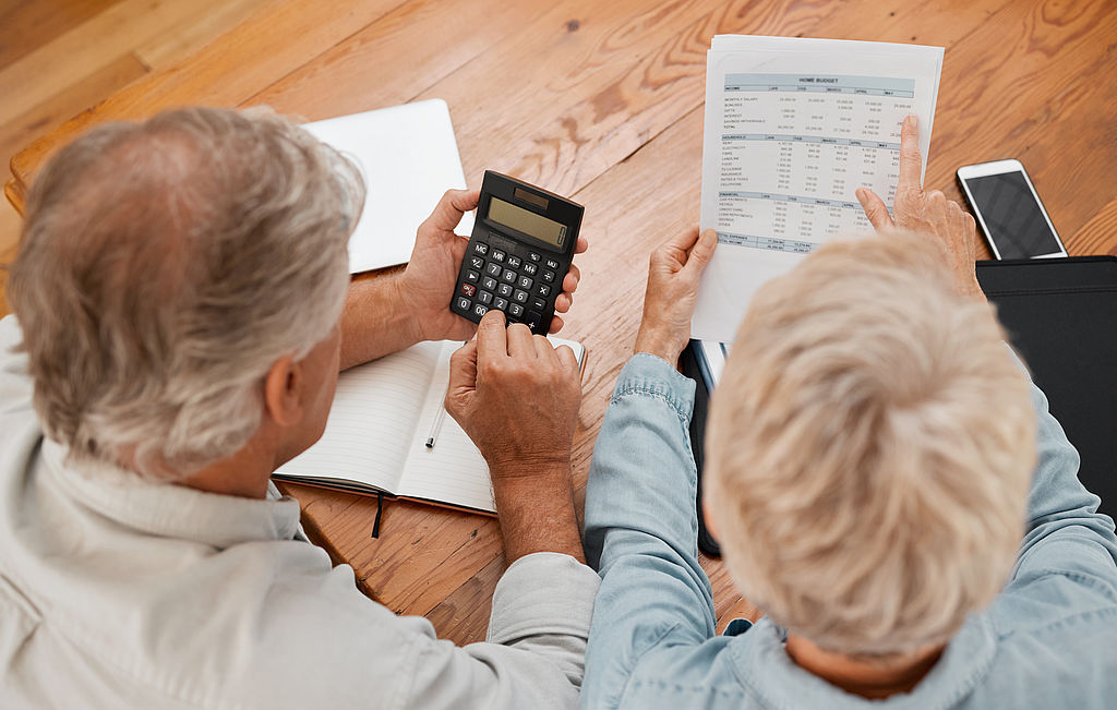 Budget, finance and senior couple with calculator planning finan