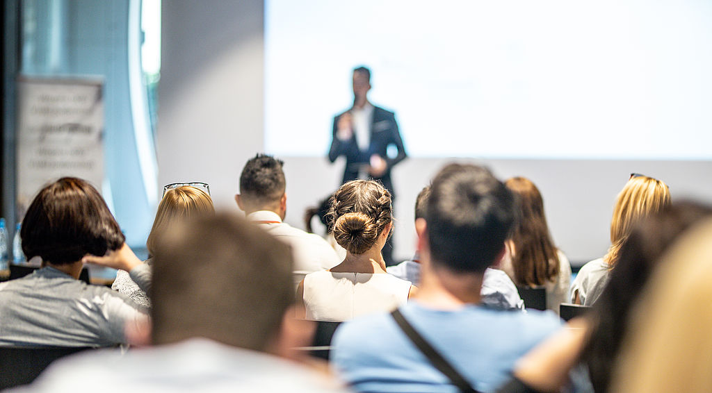 Male business speaker giving a talk at business conference event